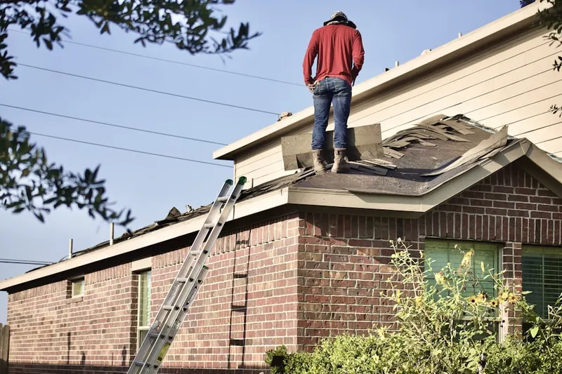 Professional roofer working on a residential roof in St. Marys
